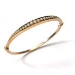 A yellow gold and pearl bangle
